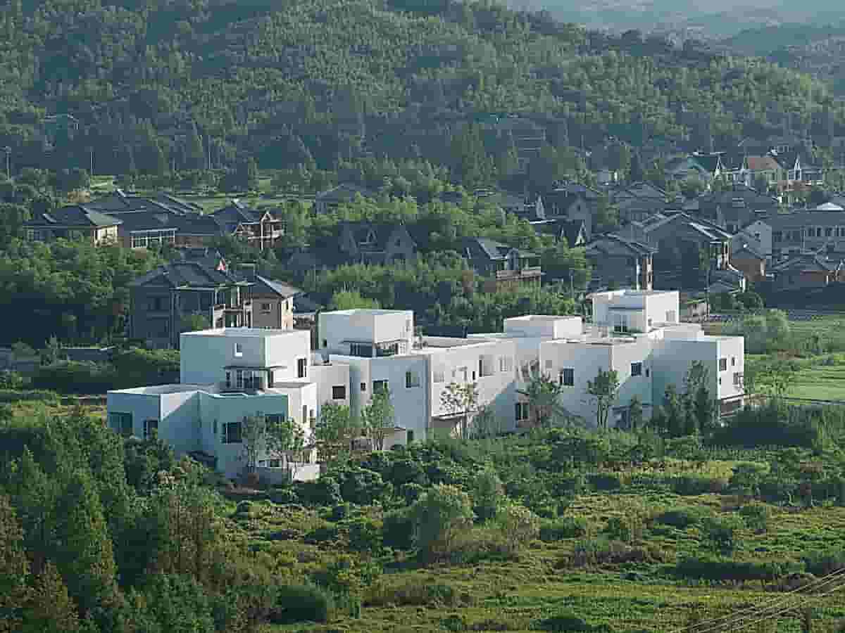 This a Village Hotel the Building is Painted White, Echoing the Colour of the Cows and the Egrets, Standing Out While Harmonizing with their Natural Surroundings