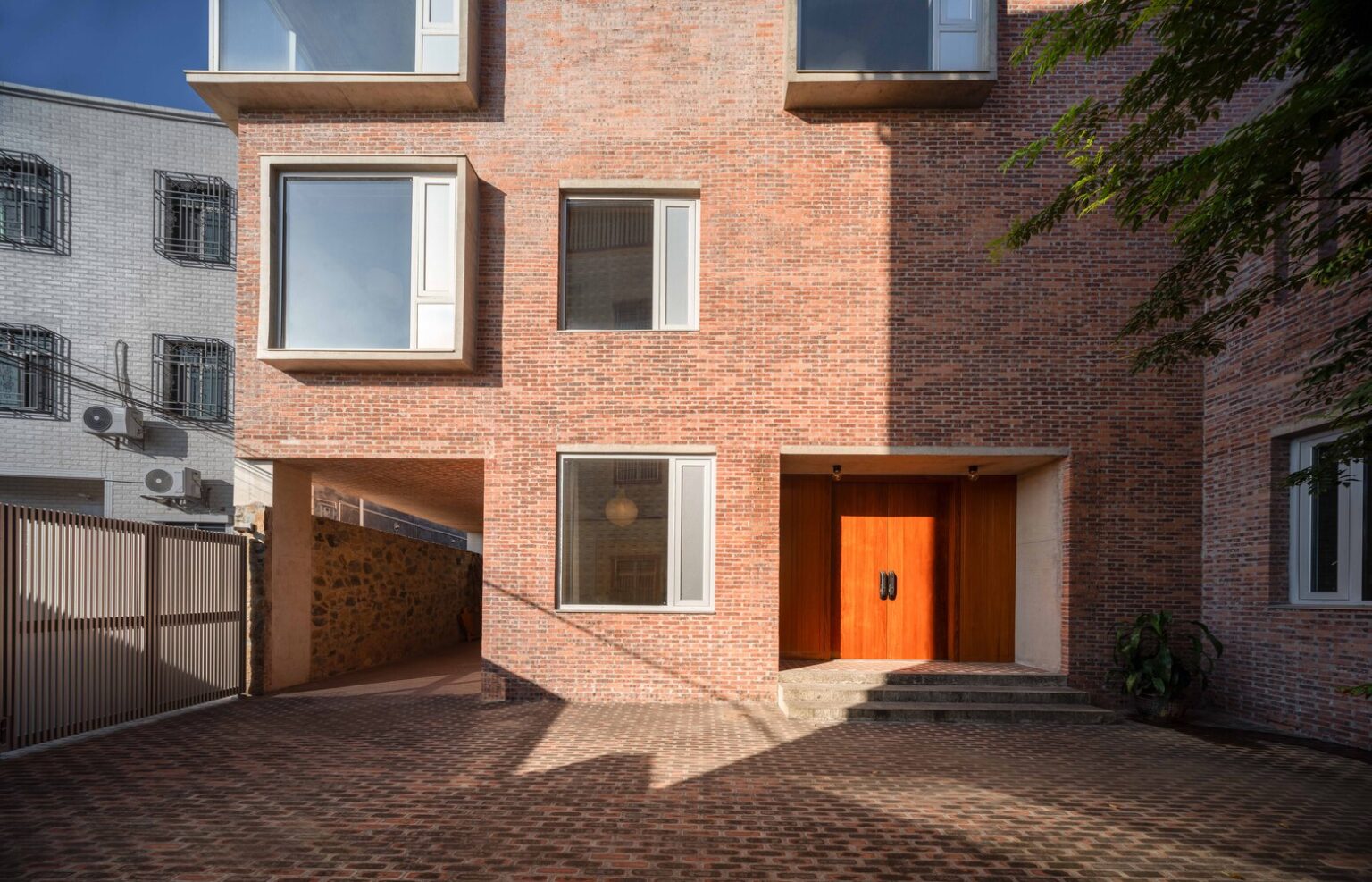 brick house light well interior with vertical light and shadow