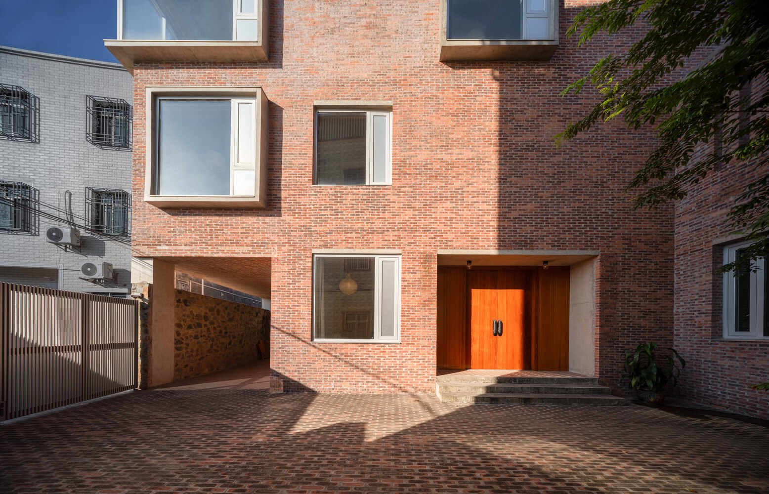 brick house light well interior with vertical light and shadow