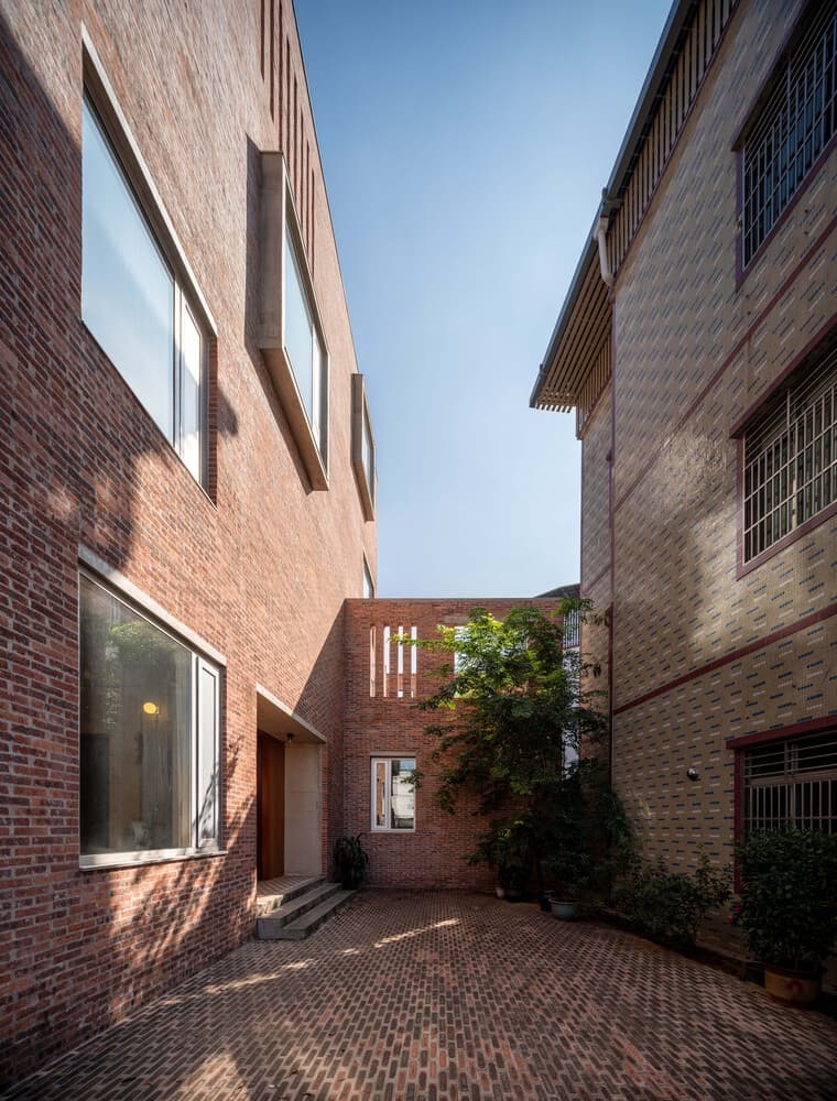 brick house courtyard exterior with layered volumes