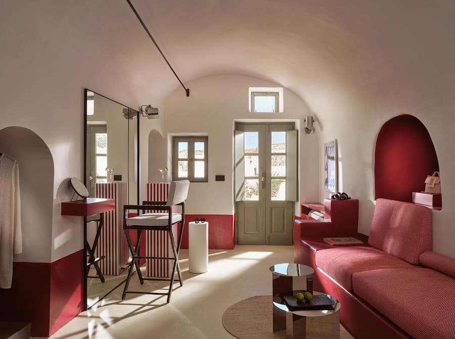 Santorini boutique hotel interior showing material as narrative design • Light and space in Cycladic cave suite Santorini 