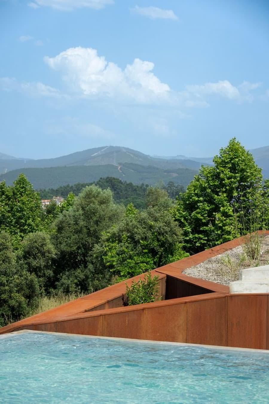 Casa Corten on forested slope in northern Portugal integrating architecture with landscape