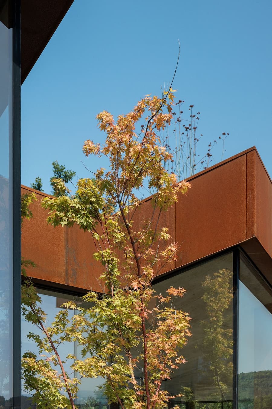 angular corten steel geometry shaping the exterior facade of the house