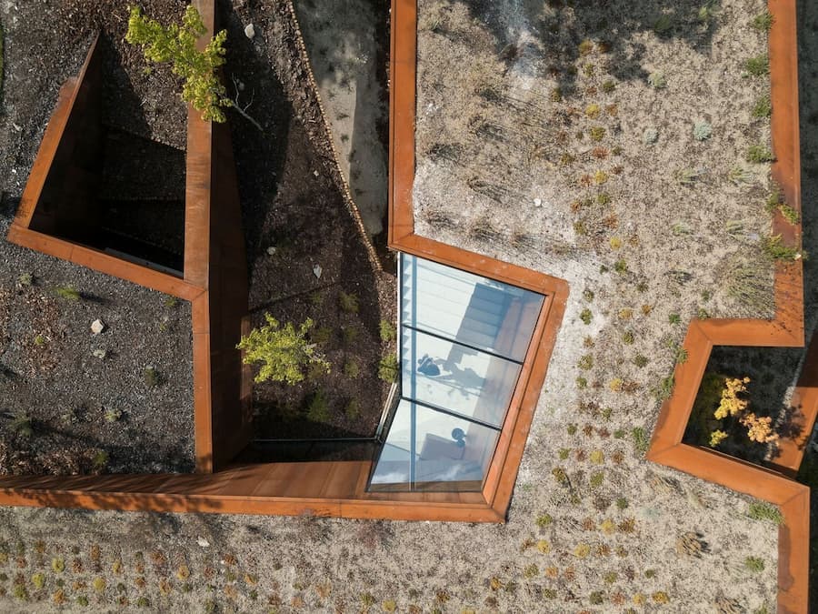 top view of Casa Corten showing geometric roof integrated with terrain