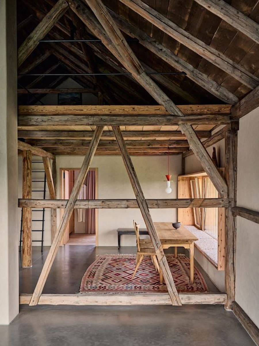 double height barn interior with exposed timber frame and open spatial layout