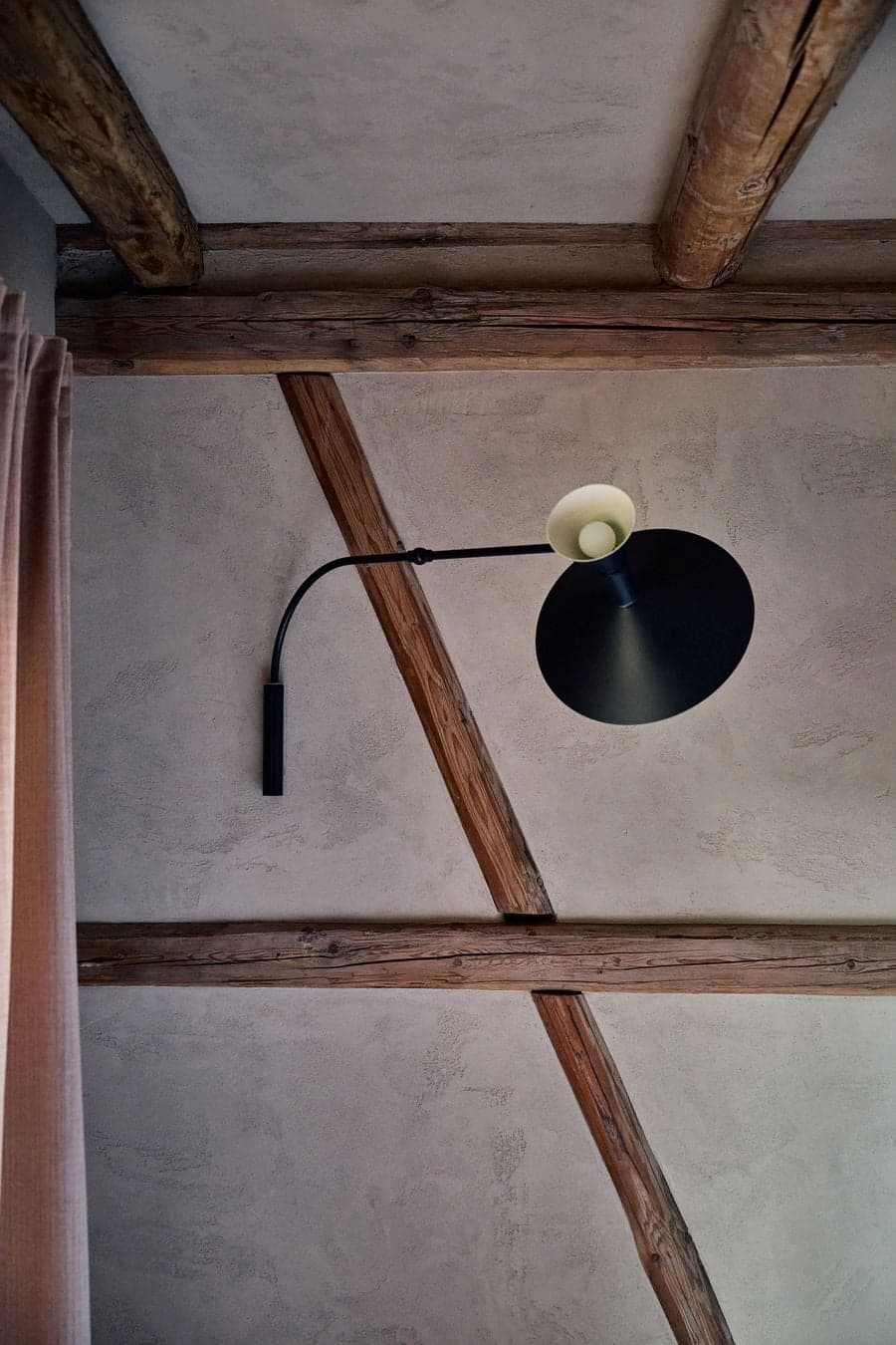 timber beam structure intersecting with plaster wall and integrated lighting