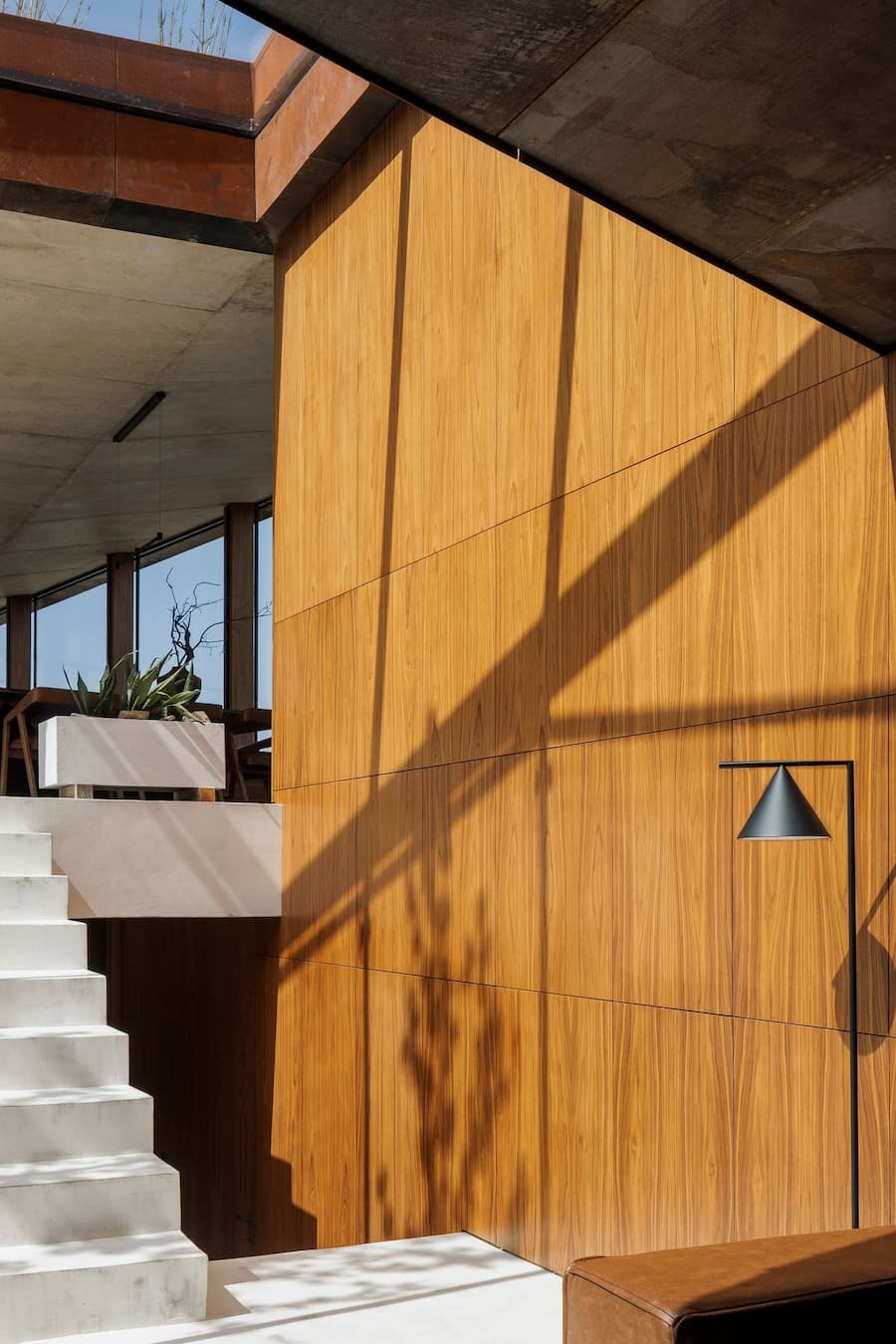 wood wall surface with shifting light revealing interior spatial depth