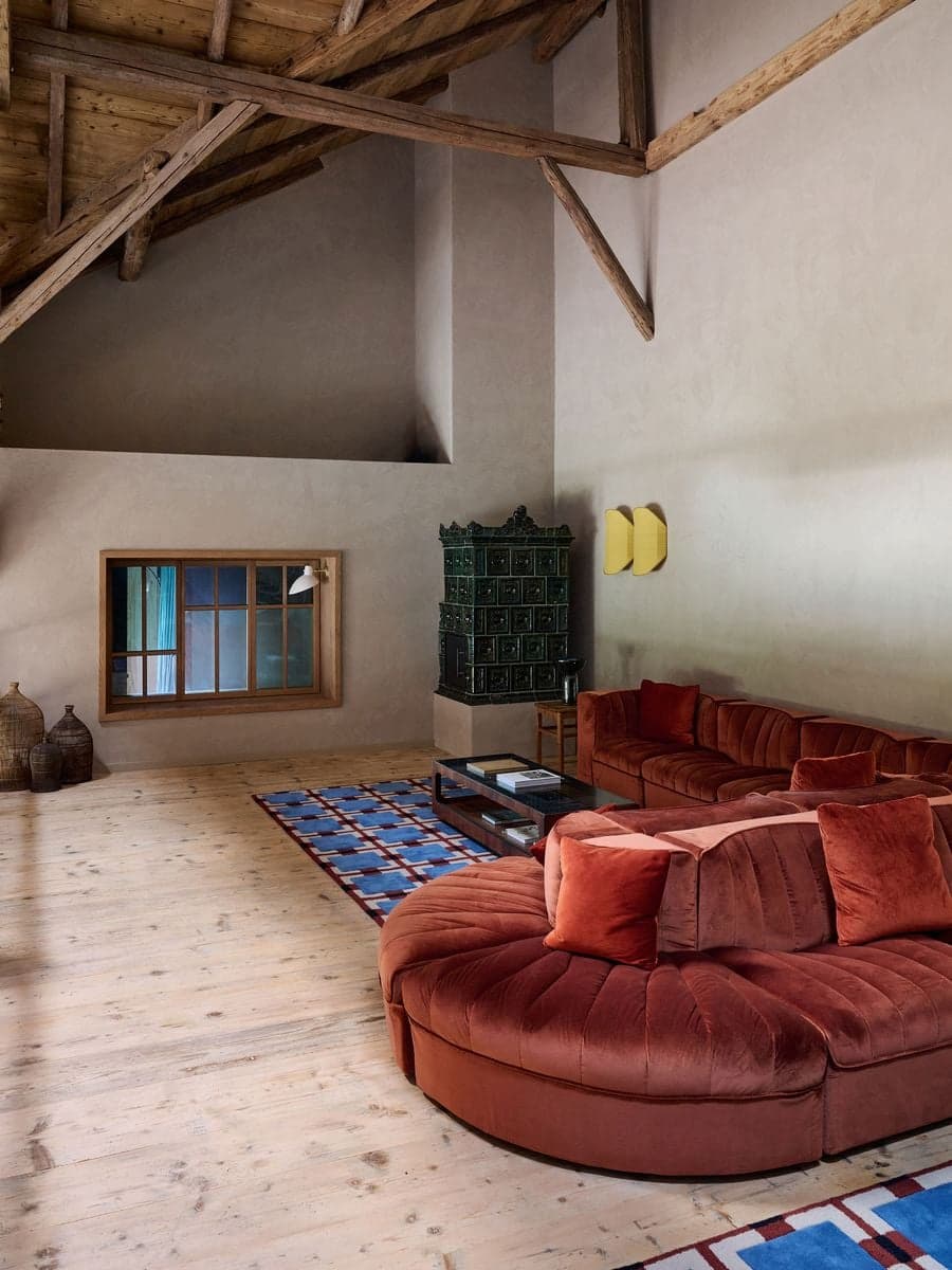 living space combining exposed timber structure with textured plaster walls