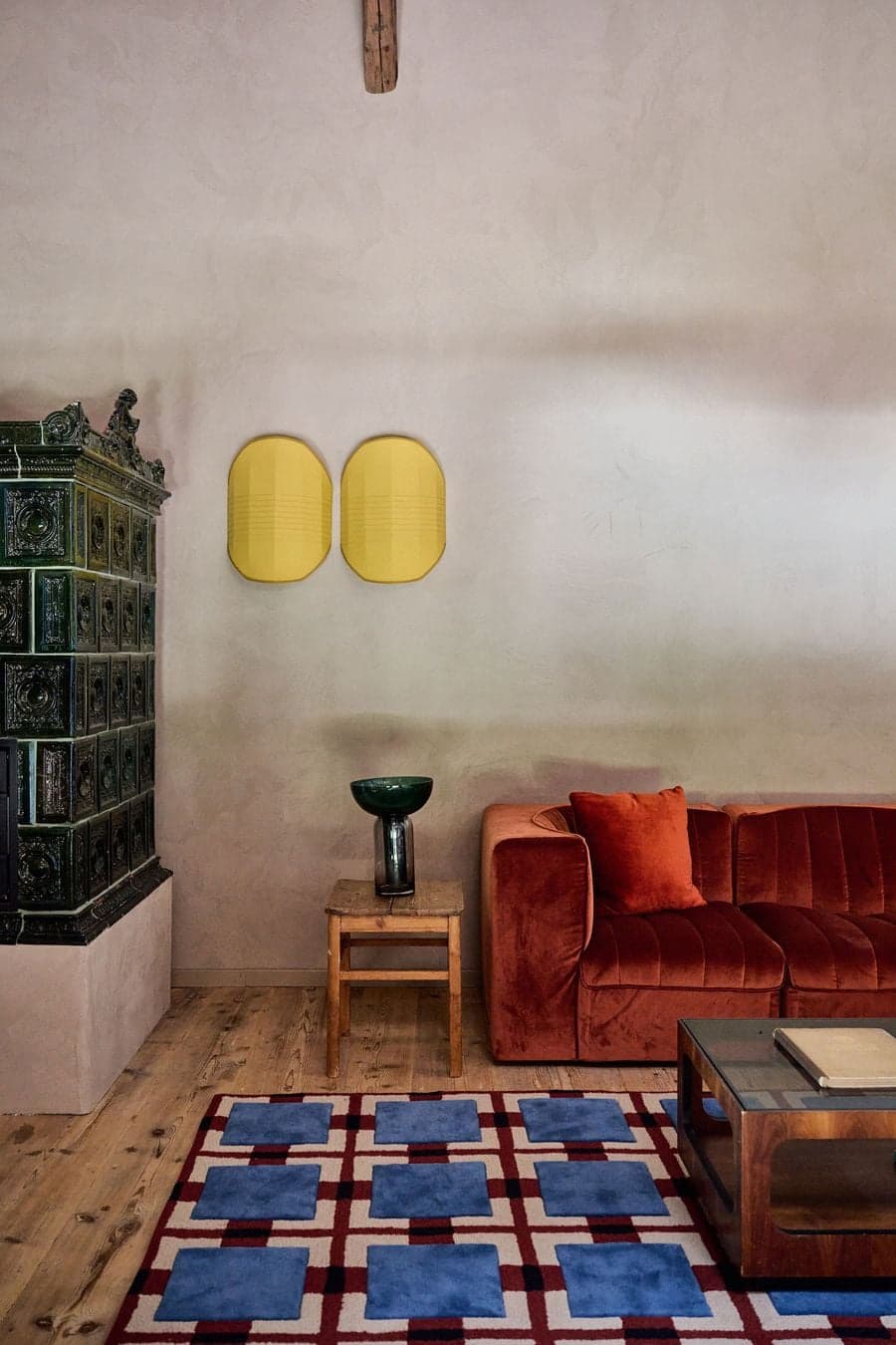 contrast between soft textile seating and raw wall surface materials