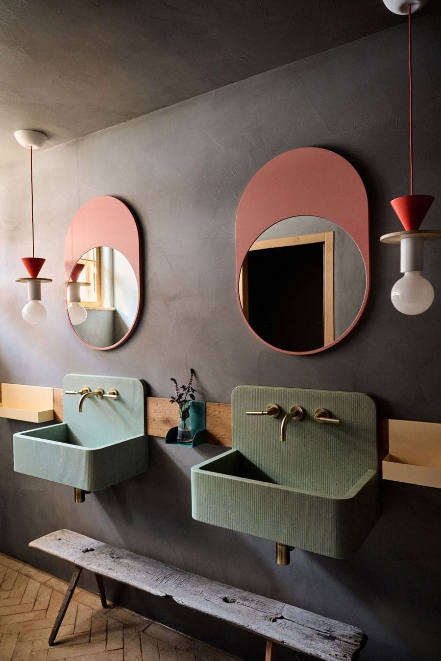 bathroom interior with colored sinks mirrors and textured wall finishes