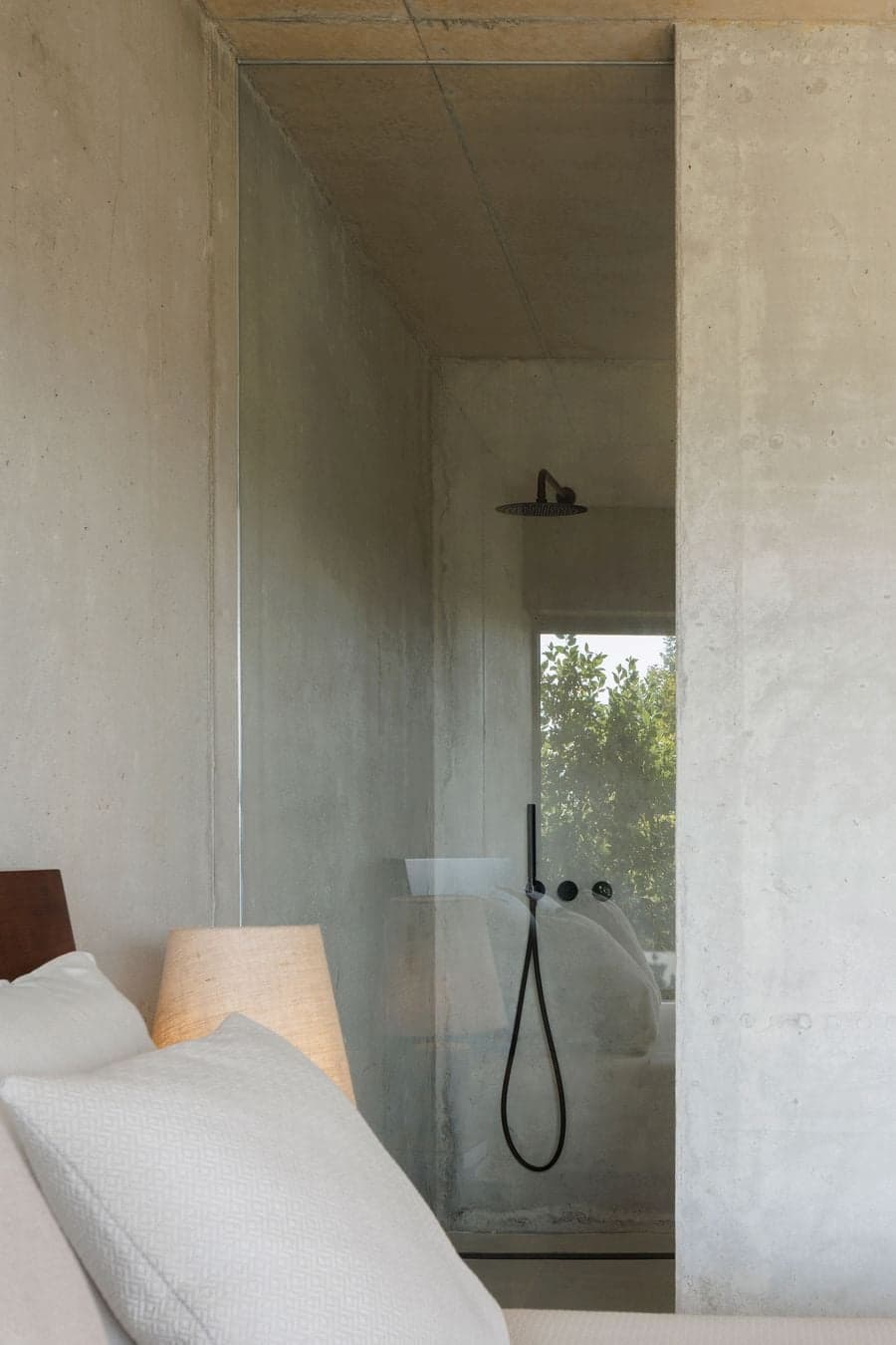 minimal concrete bathroom space integrated within architectural structure