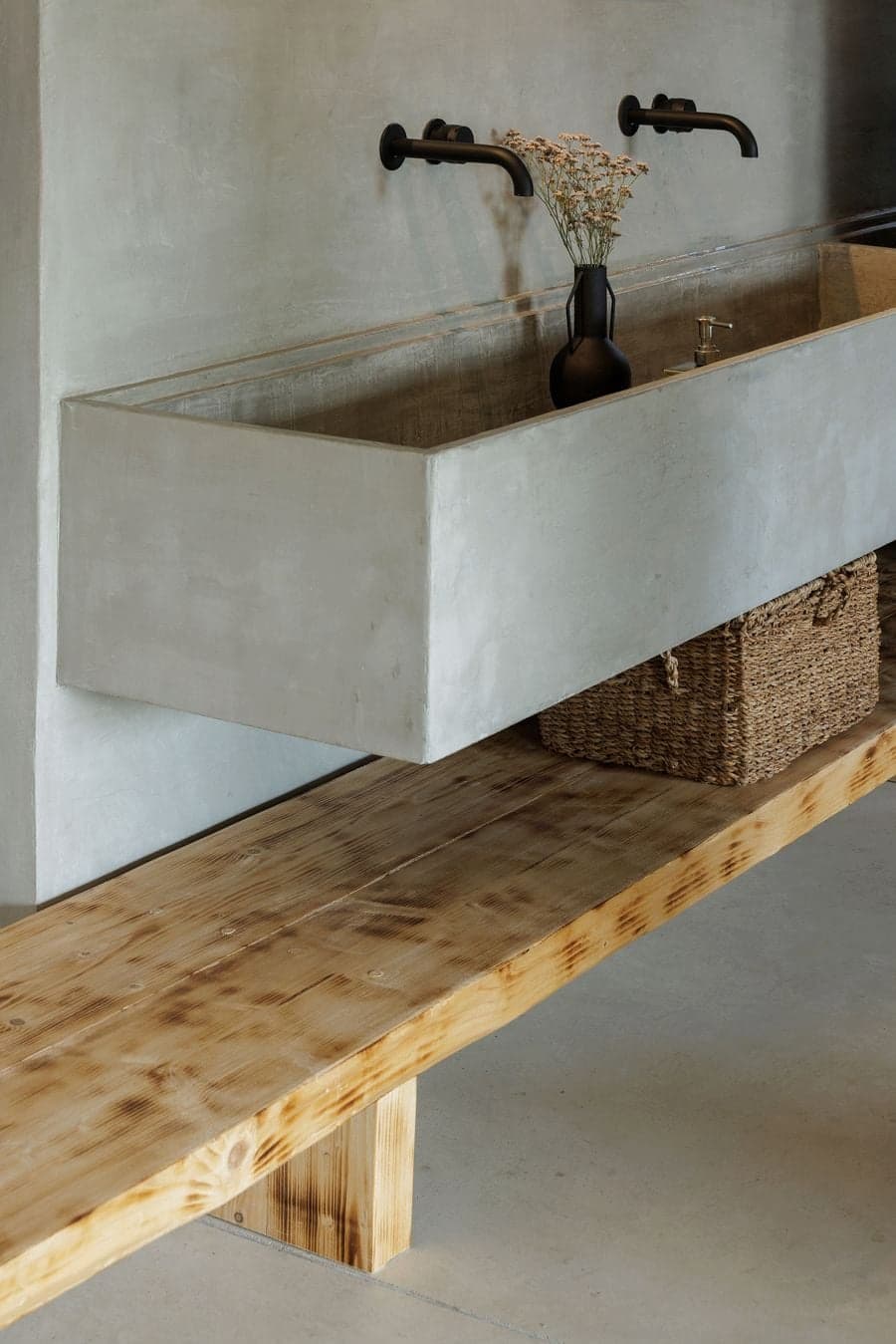 material detail of concrete sink and wood surface within interior composition