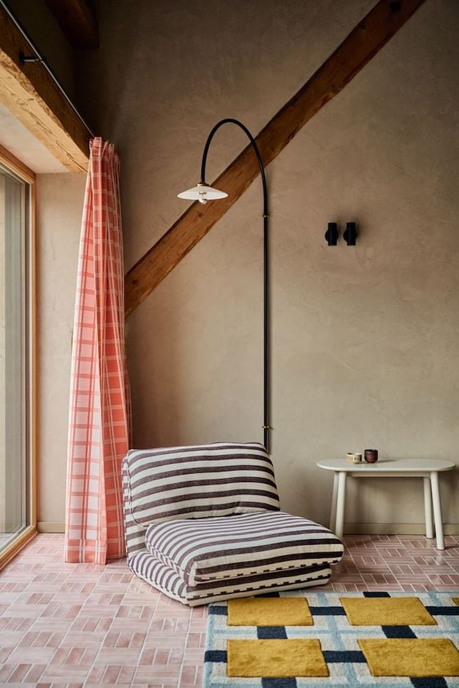 relaxing seating area next to window with soft textiles and natural light