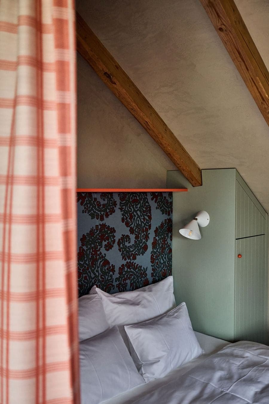 built in bed niche integrated with storage and sloped ceiling