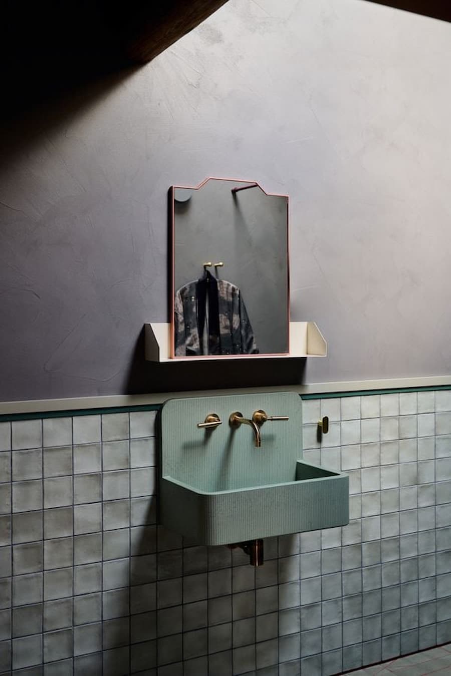 wall mounted sink integrated with tiled surface and minimal fixtures