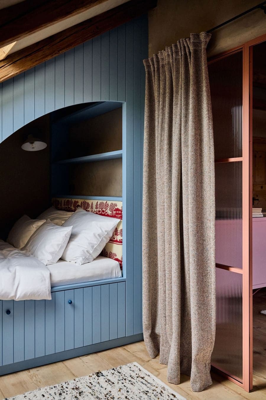 bed alcove enclosed with curtain creating intimate sleeping space