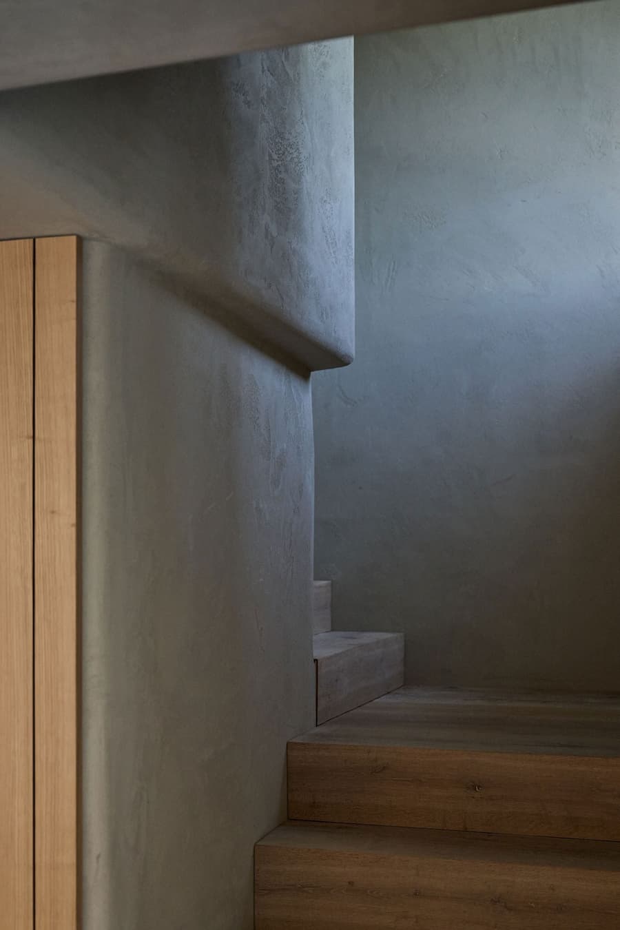 staircase corner showing transition between wood steps and plaster walls
