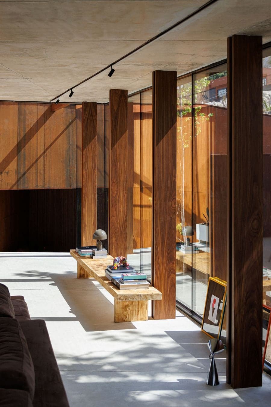 wood columns aligned with glass facade creating layered depth and structural rhythm