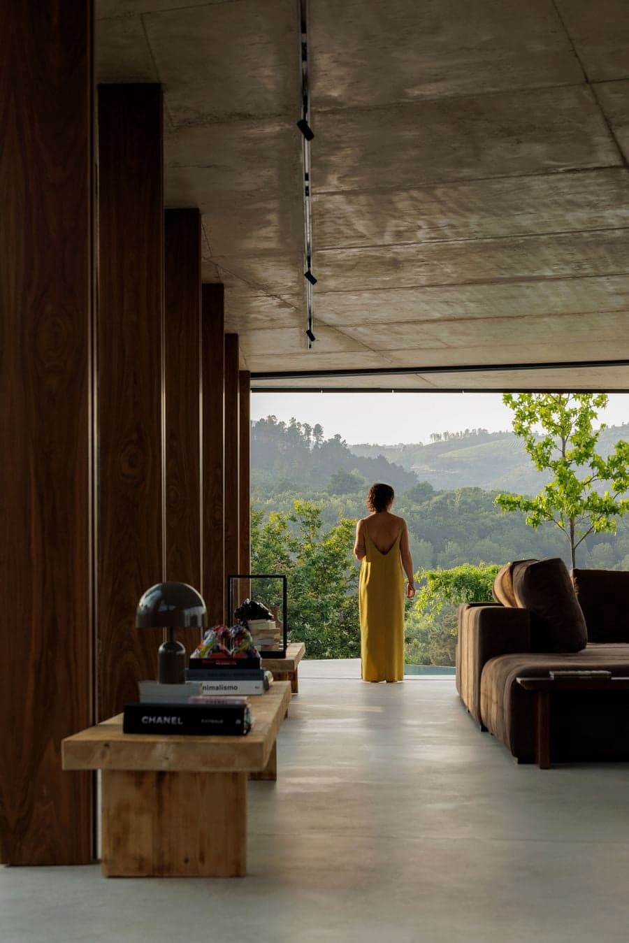 living area opening toward landscape through full width glazing extending visual continuity