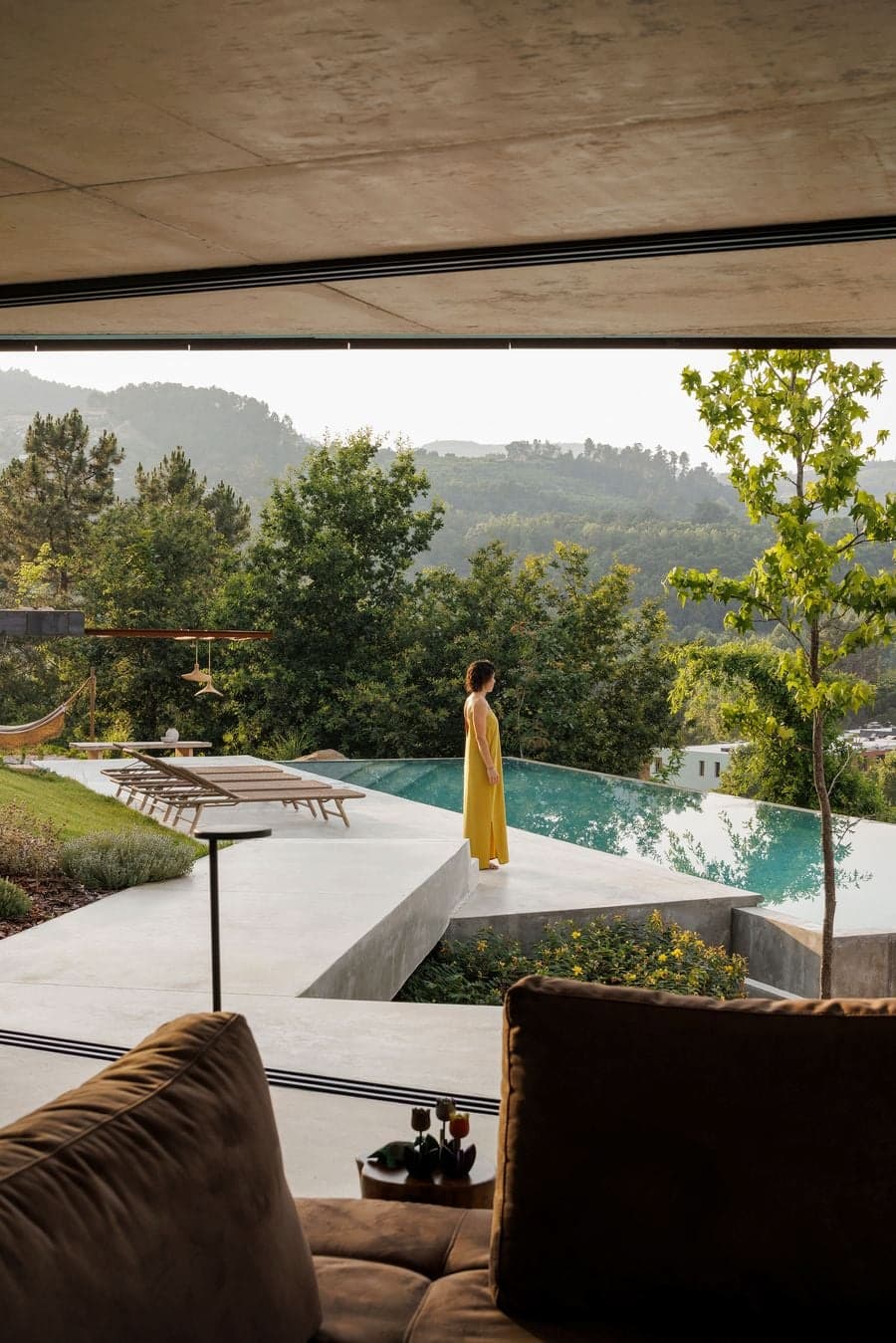 interior threshold dissolving into exterior terrace maintaining continuous floor and ceiling plane