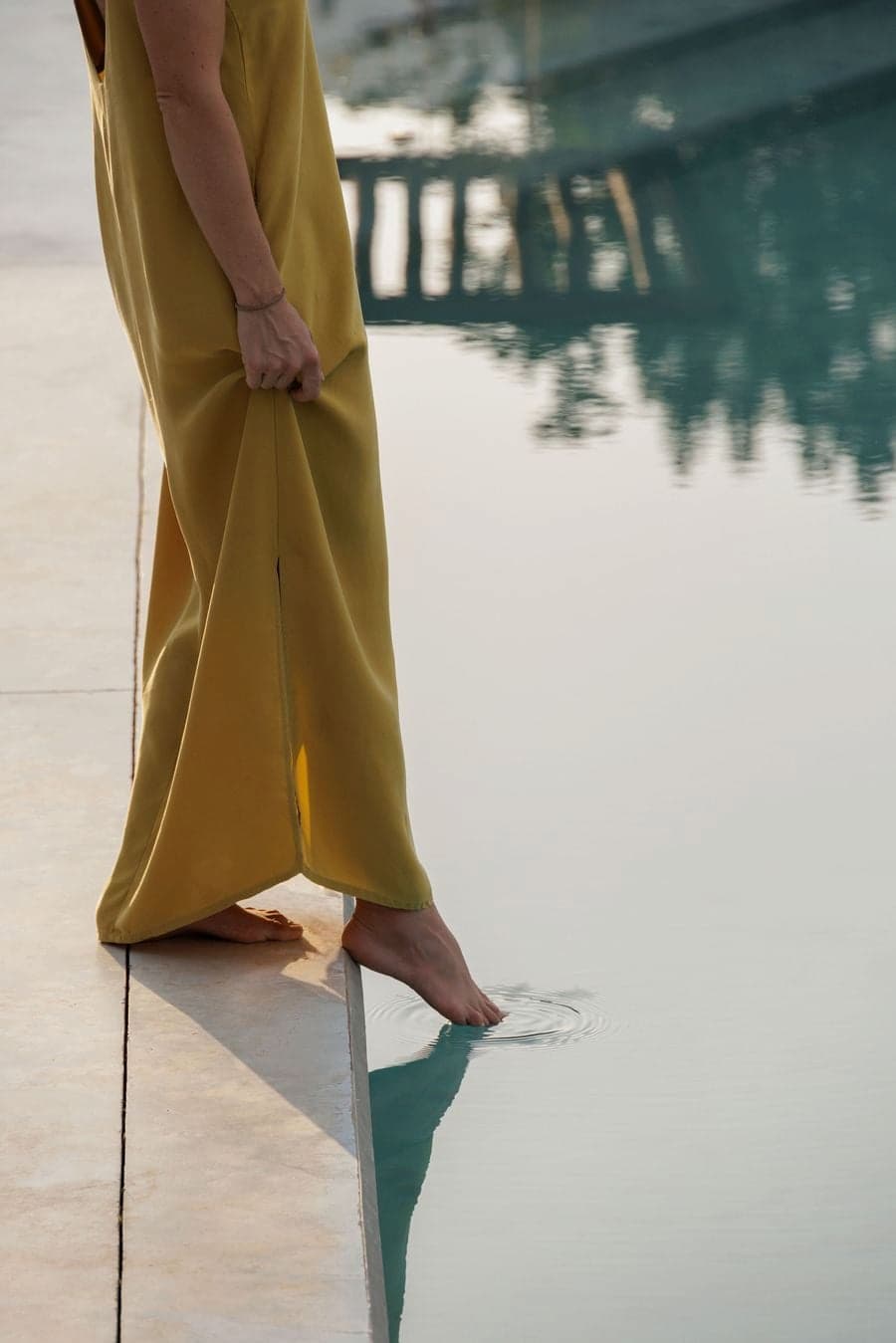 concrete platform extending toward pool edge integrating built surface with surrounding landscape 