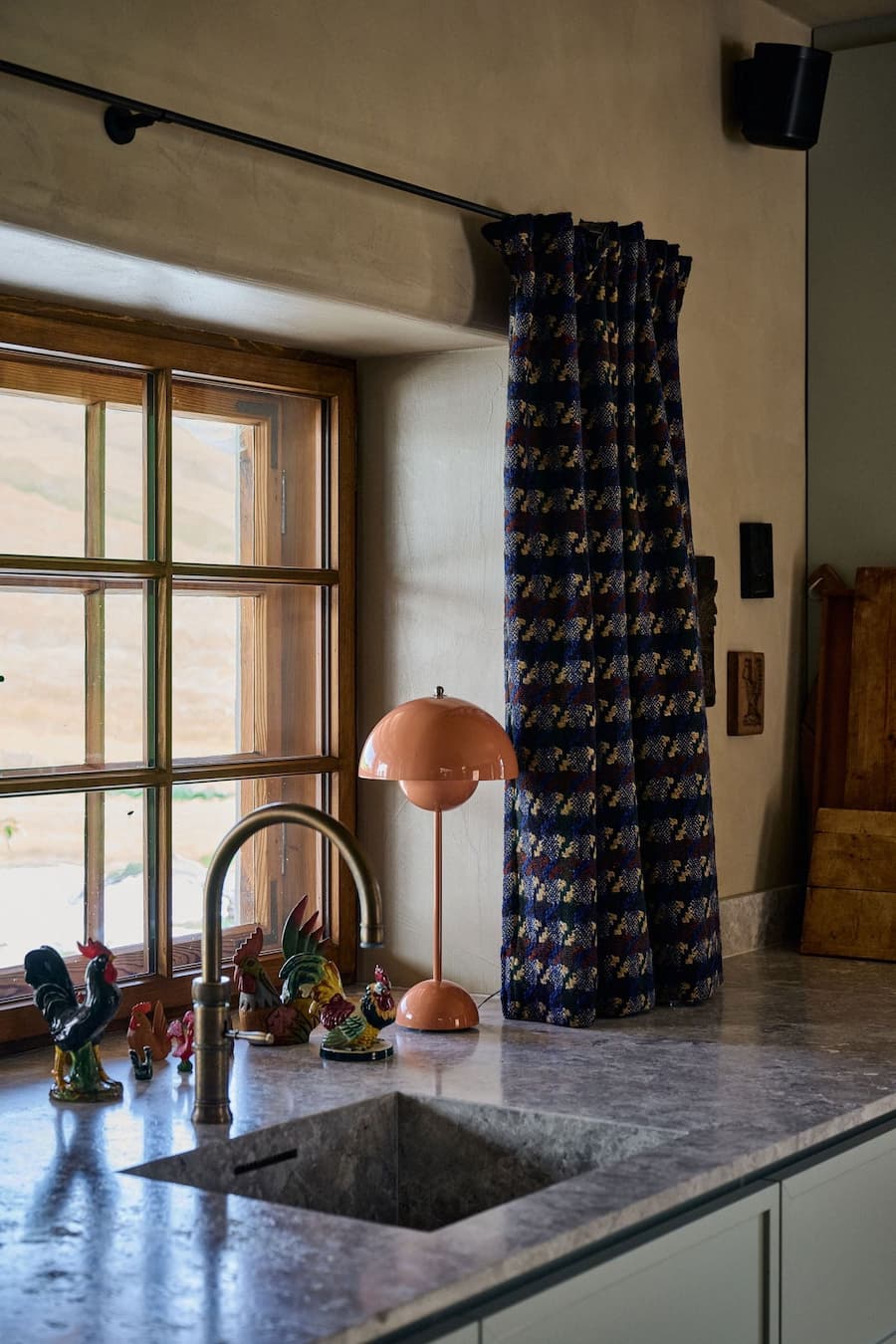 kitchen with stone countertop and window side setup allowing natural light to enhance everyday use