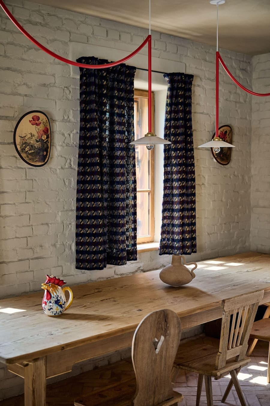 dining interior with exposed brick wall patterned curtains and daylight shaping spatial rhythm