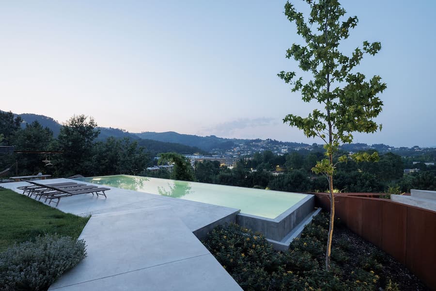 pool and terrace integrated within vegetation with filtered natural light across surfaces