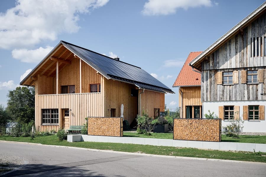 wooden house exterior in rural setting showing continuity of material language from inside to outside