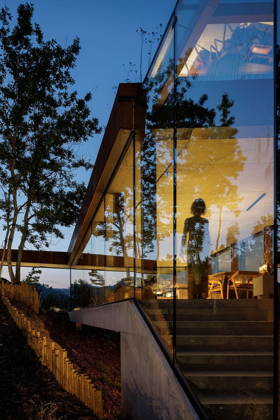 glass corner opening aligning interior circulation with exterior terrain transition