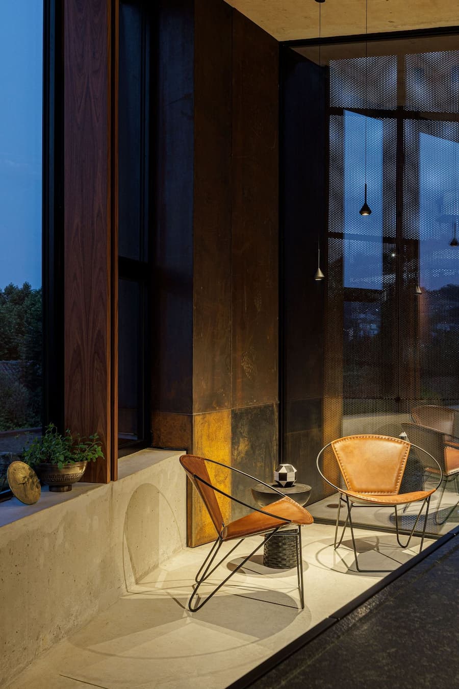 glass facade reflecting surrounding vegetation while revealing structural depth and interior layers