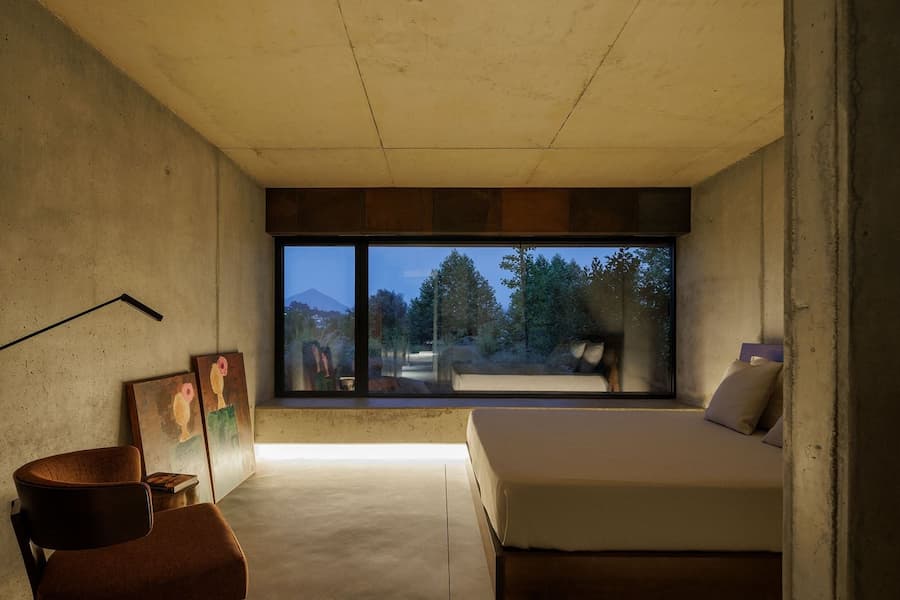 dining space composed of wood concrete and glass defining spatial hierarchy through material contrast 