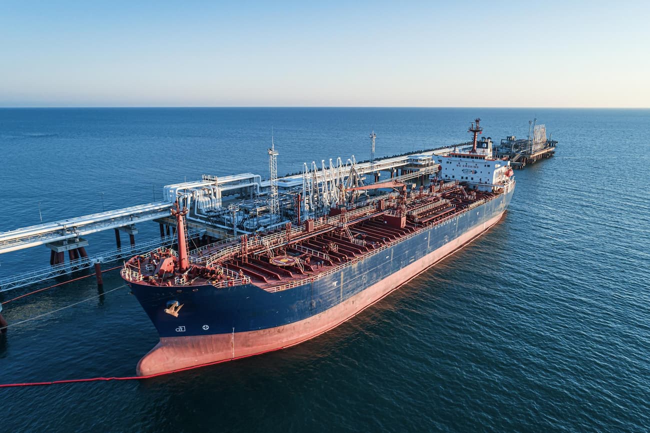 oil tanker docked at an industrial port, illustrating global petroleum transport and distribution infrastructure
