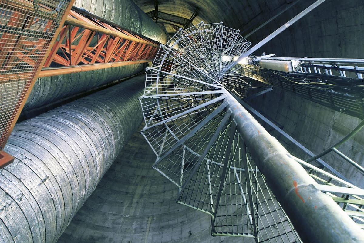 vertical view of industrial pipelines and structural systems, representing complex energy infrastructure networks 