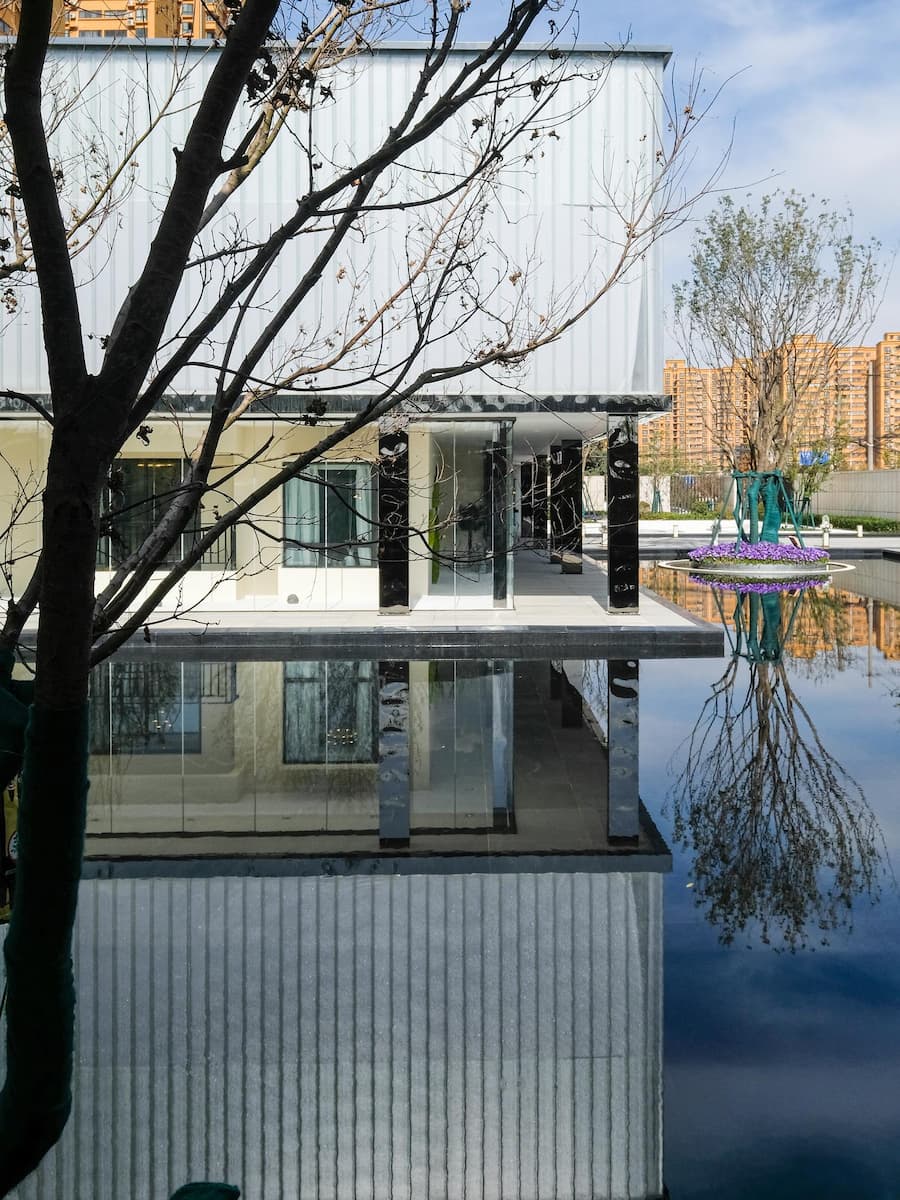 natural light reflecting on a still water surface, mirroring architecture and softening the boundary between interior and exterior