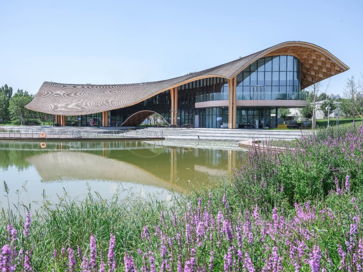 landmark timber architecture with flowing roof integrated into lakes landscape