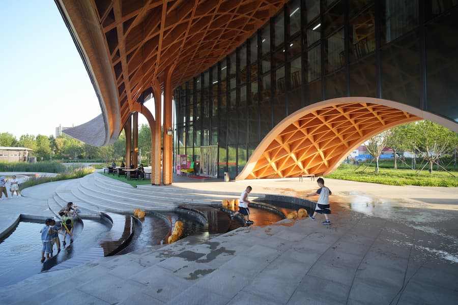 shaded space under timber canopy with structural lattice and glass enclosure