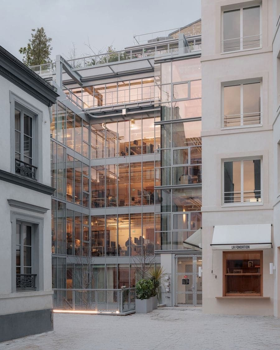 Glass facade and courtyard view of La Fondation mixed-use redevelopment in Paris