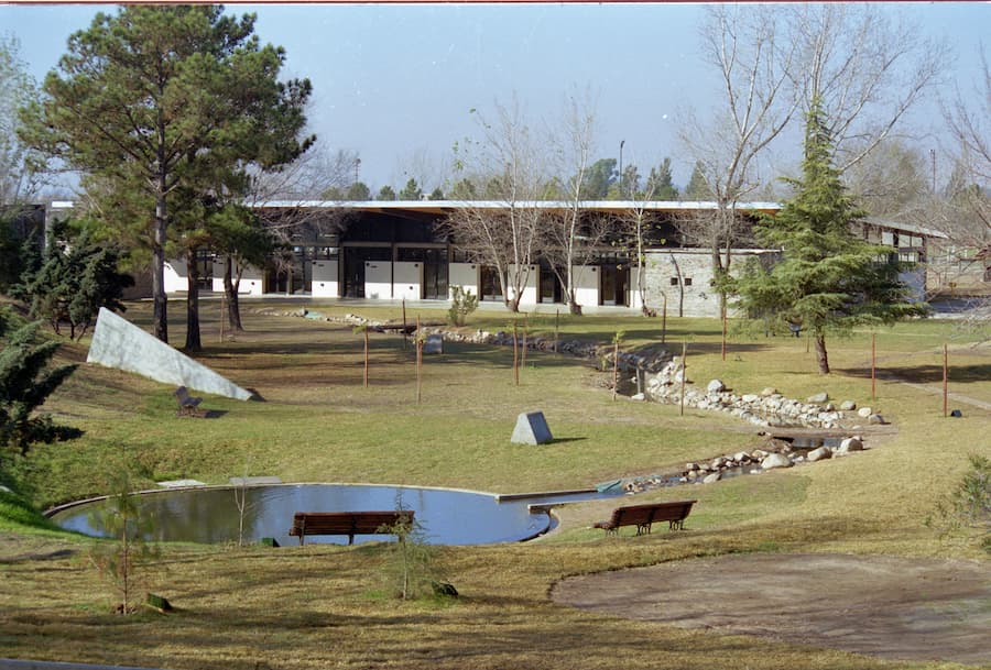 children interacting with rain and outdoor learning environment integrated into natural landscape