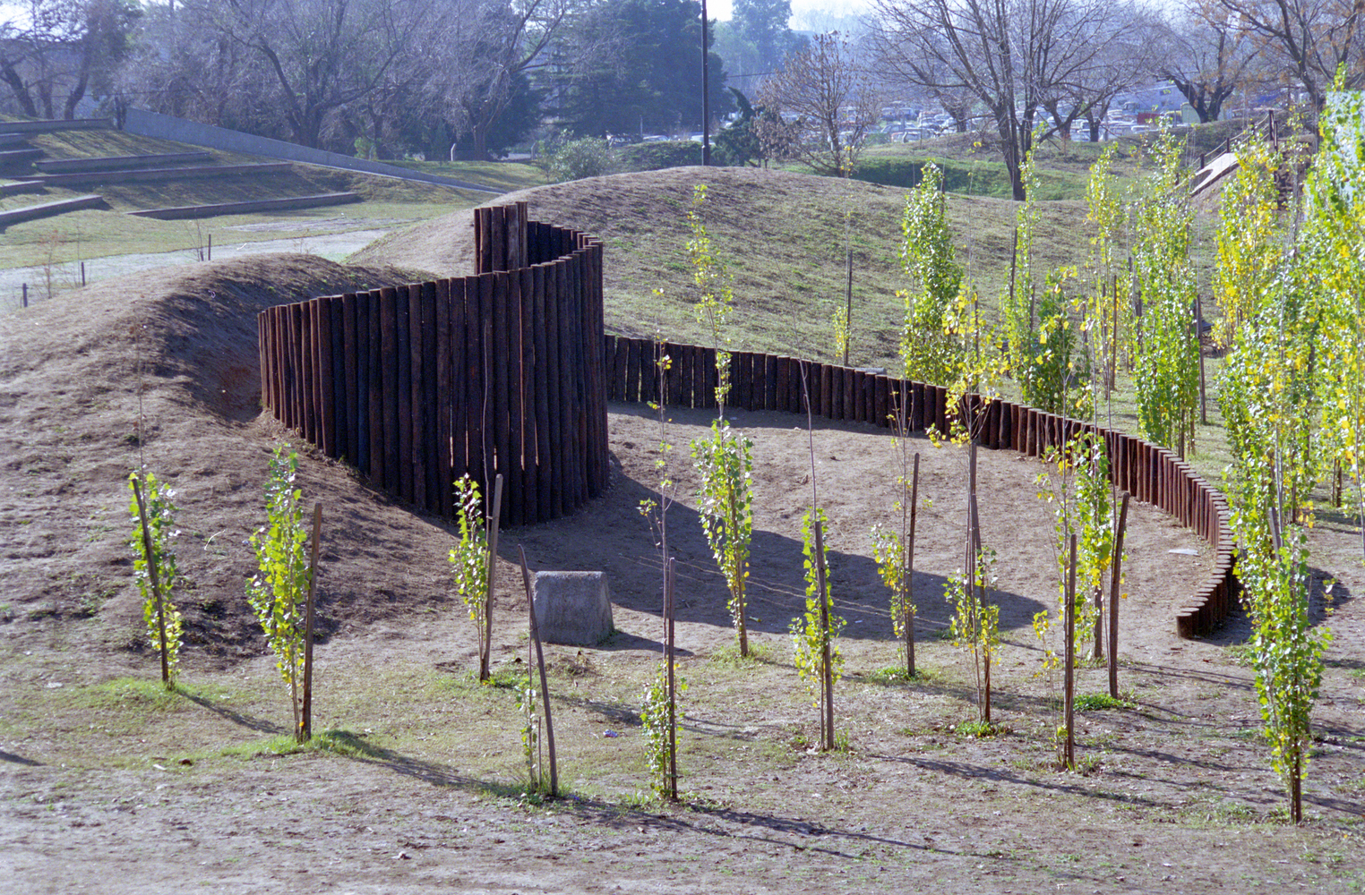 sculpted earthwork landscape forming immersive outdoor play and exploration environment