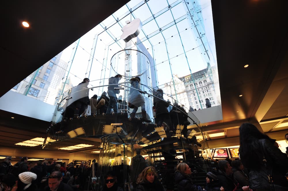 Glass staircase inside Apple Store creating spatial transition