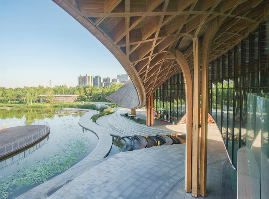 large span timber arches connecting building structure to lakeside environment