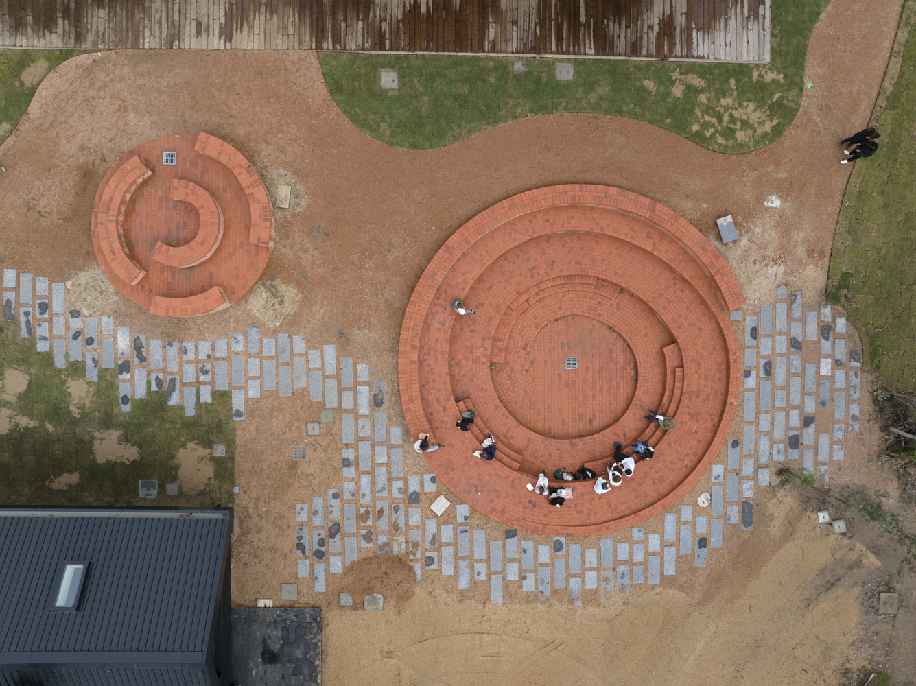 aerial view of circular brick gathering spaces designed for community interaction and play
