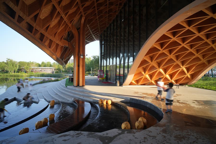 timber structure forming entrance space with curved architectural geometry