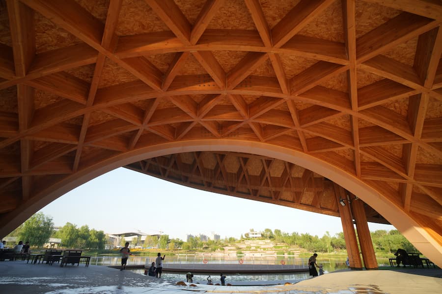 overall building view along lake showing integration with landscape