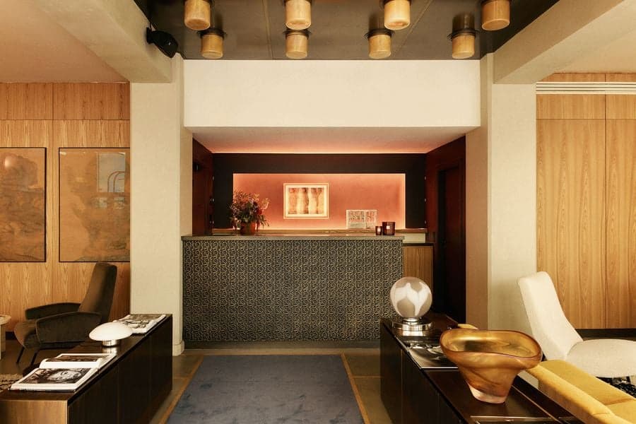 Material palette and reception area within a La Fondation hotel suite