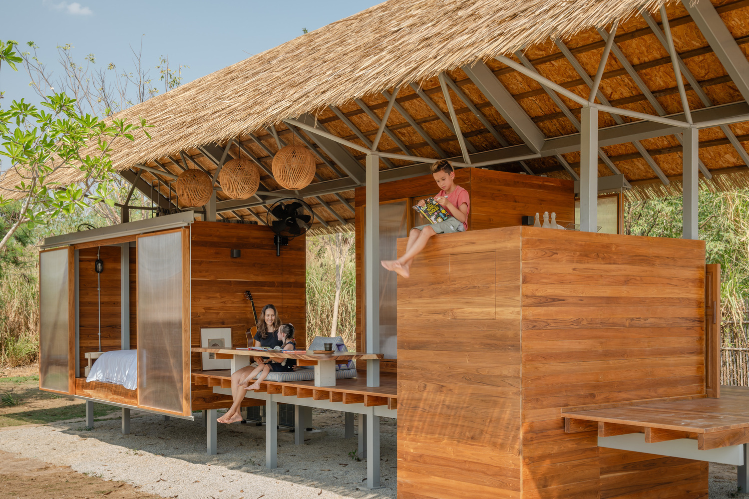 open tropical interior with flexible living platforms beneath lightweight roof structure