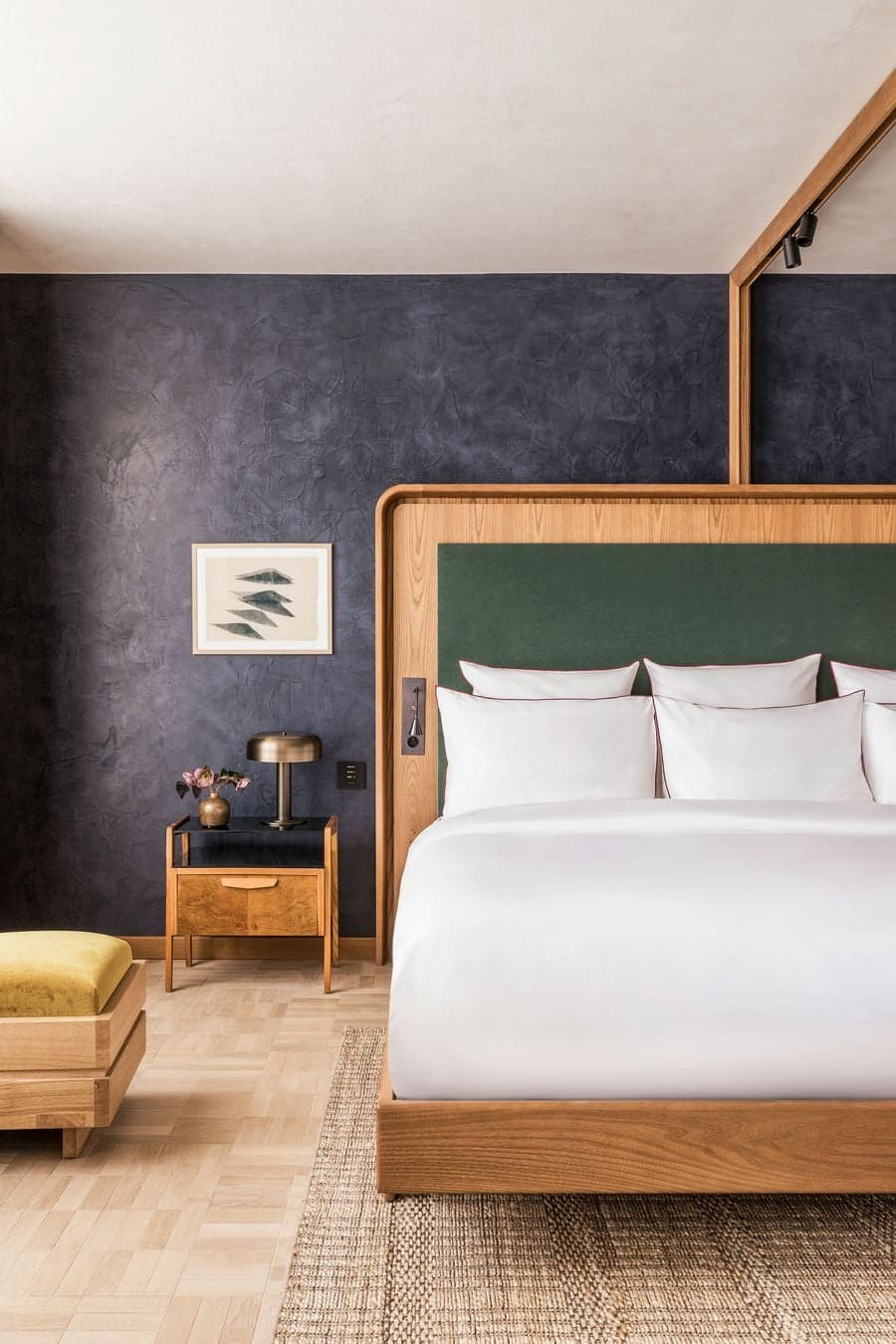 Bedroom interior with dark blue textured walls at La Fondation Paris