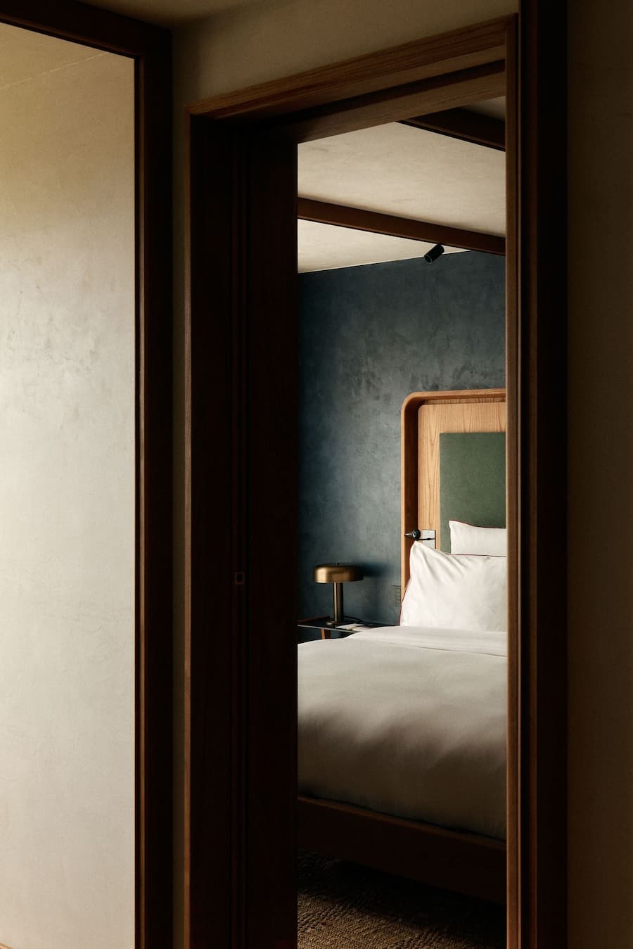 Framed bedroom view and timber detailing inside La Fondation hotel