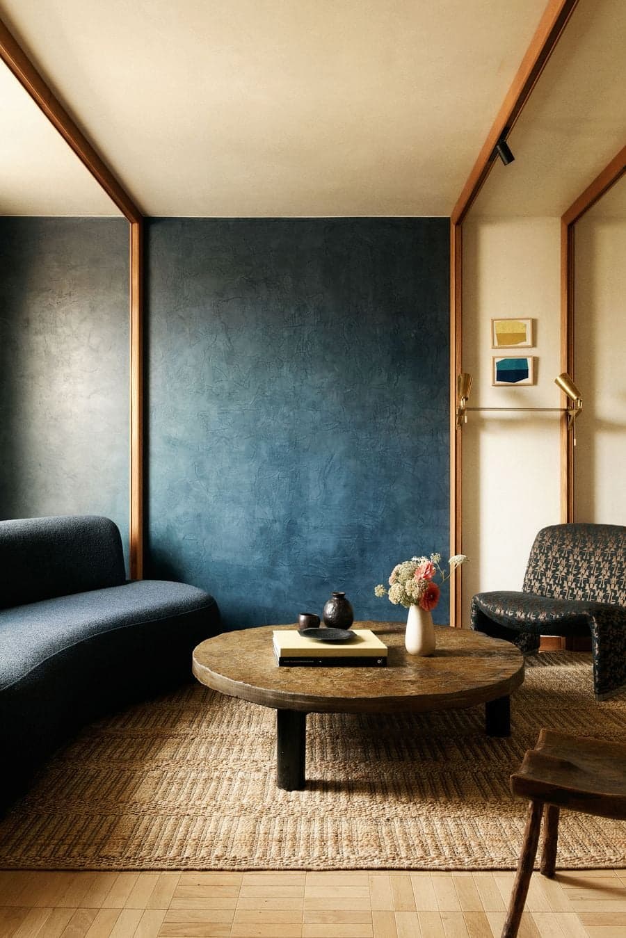 Living room with textured blue wall and custom furniture at La Fondation